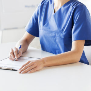 A nurse writing in a notepad