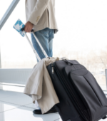 A man carrying bags at an airport