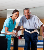 An occupational therapist helping a patient walk