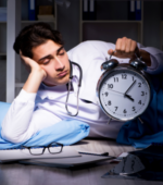 A medical professional tired on the floor with a clock