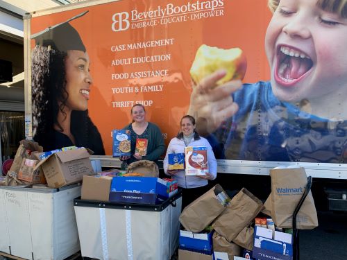 employees with 2022 thanksgiving food drive donation cart