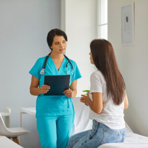 A nurse speaks with a patient