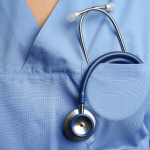 A close-up of a stethoscope inside a nurse's pocket 