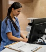 A nurse working at a computer