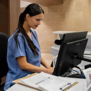 A nurse working at a computer