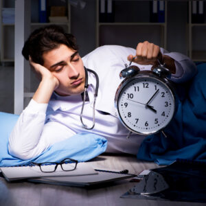 A medical professional tired on the floor with a clock