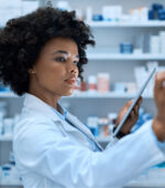 A pharmacist looking at medication stocks