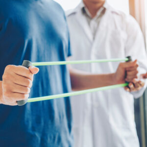 A physical therapist helping a person with a tension exercise