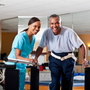 An occupational therapist helping a patient walk