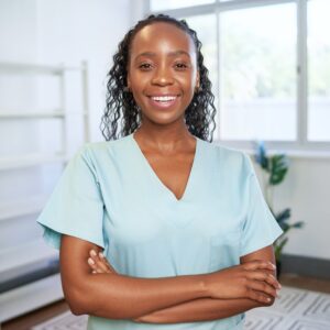 A medical worker poses and smiles for a photo