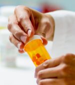A pharmacist putting medication into a pill bottle