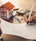 A person signing a mortgage document