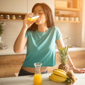 A woman drinking orange juice