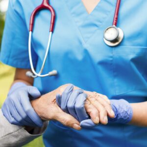 A nurse holding a patient's hand