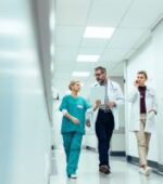 float pool nurse walking and talking with other facility staff